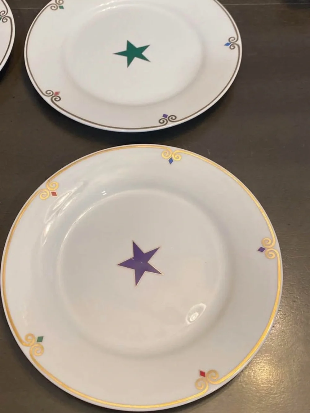 Pier 1 White  Plates with Multicolor Star Accents and Gold Trim